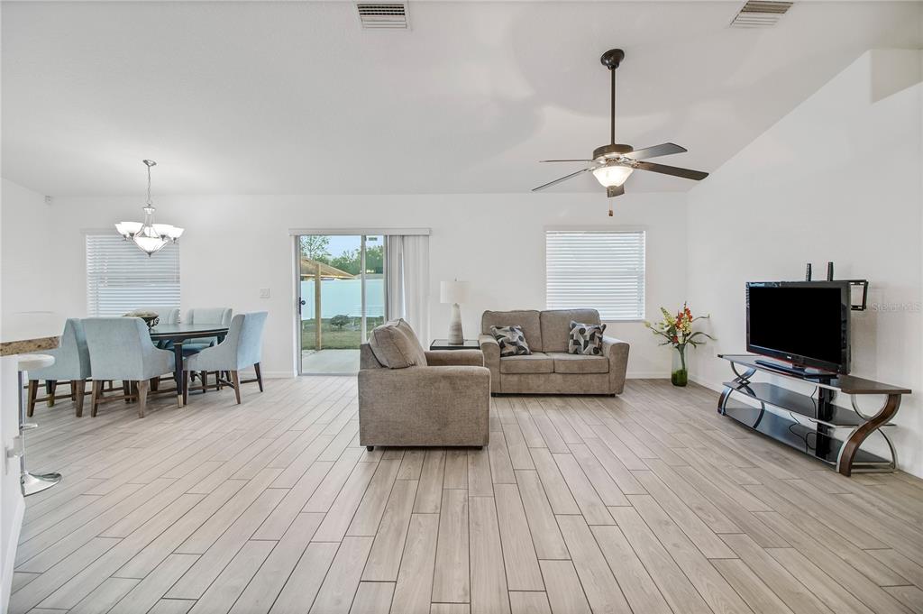 314 Stone Castle Loop Lady Lake, FL 32159 - Photo 10 of 42 a living room with furniture and a flat screen tv