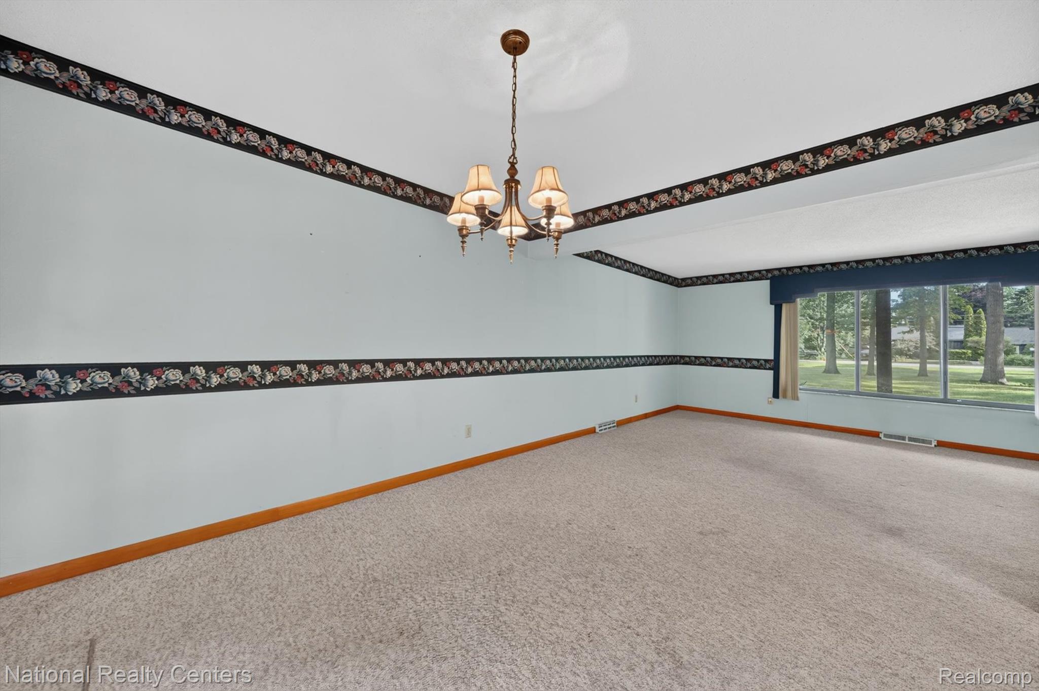 3107 Dean Road Lambertville, MI 48144 - Photo 14 of 45 Spacious room with light blue walls, textured carpet, and a large window