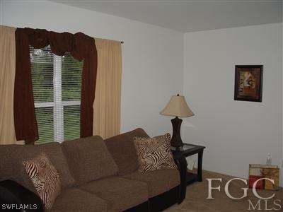 2134 Armour Road Lehigh Acres, FL 33973 - Photo 3 of 10 a bedroom with a bed and a window