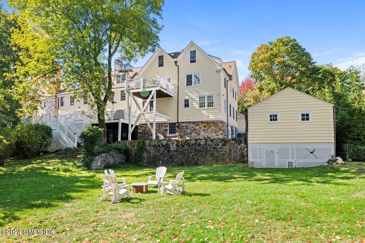 43 Maple Avenue, Unit 2 Greenwich, CT 06830 - Photo 13 of 17 a front view of a house with garden
