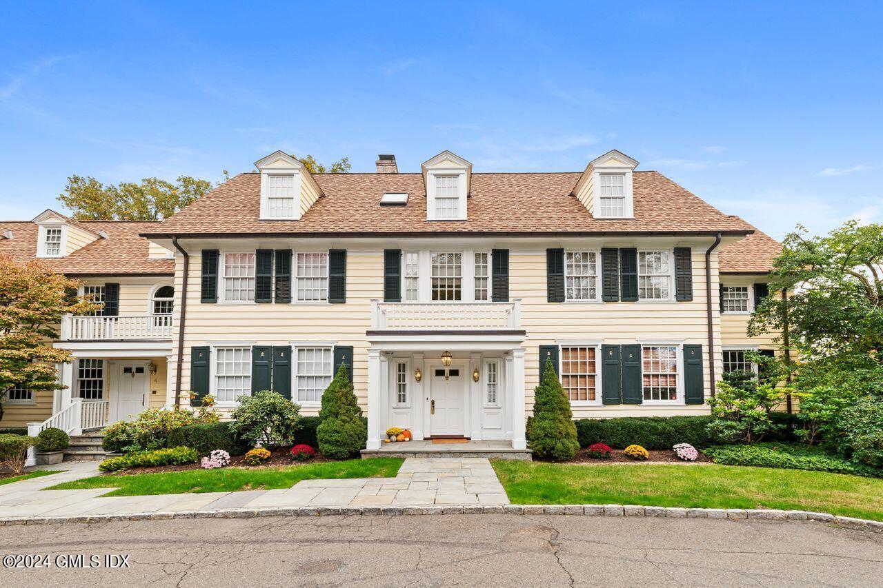 43 Maple Avenue, Unit 2 Greenwich, CT 06830 - Photo 2 of 17 a front view of a house with a garden and plants