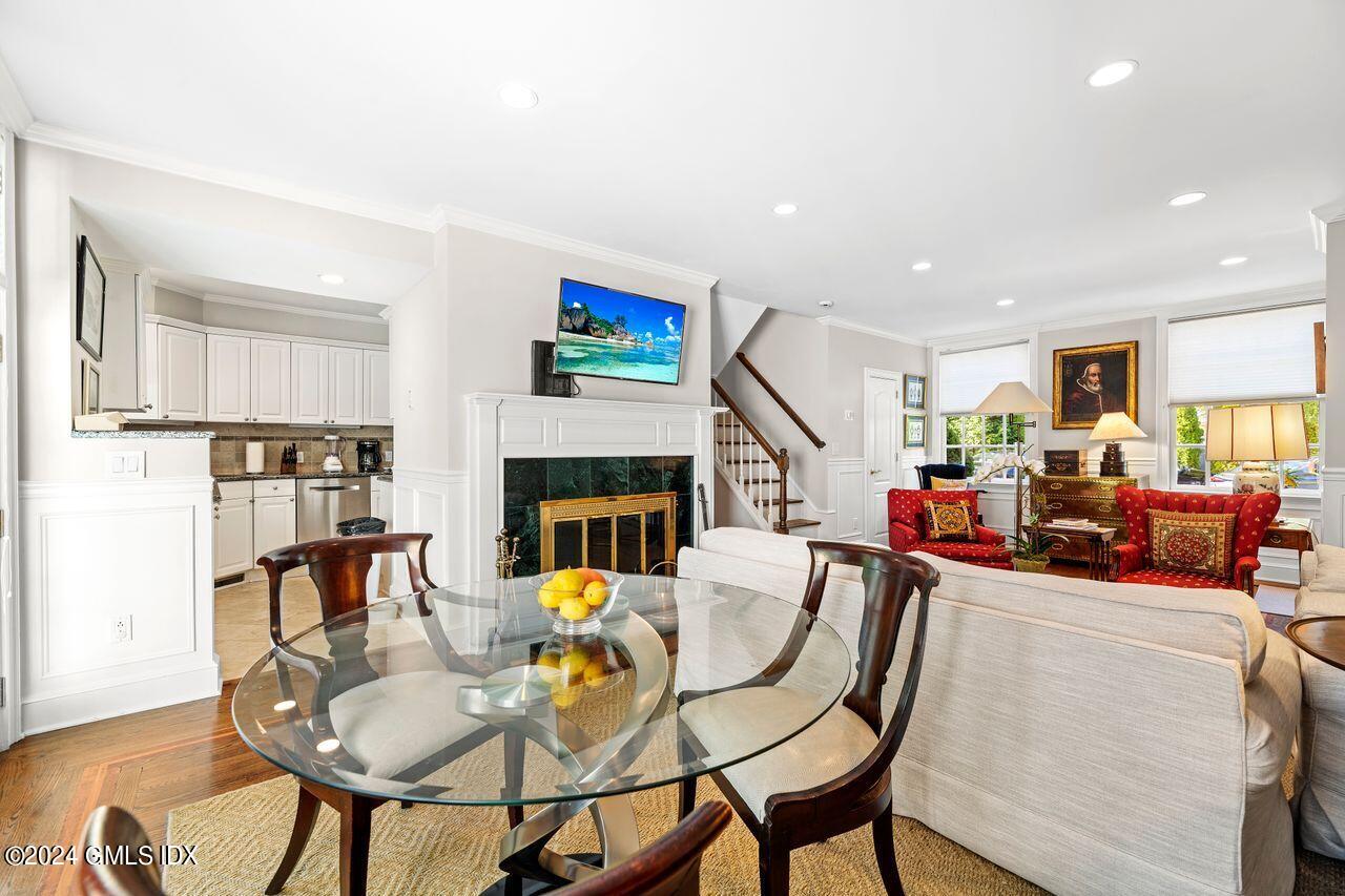 43 Maple Avenue, Unit 2 Greenwich, CT 06830 - Photo 5 of 17 a view of a dining room with furniture and a fireplace