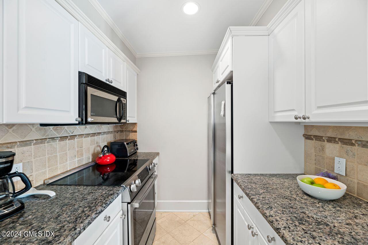 43 Maple Avenue, Unit 2 Greenwich, CT 06830 - Photo 6 of 17 a kitchen with granite countertop a sink and cabinets
