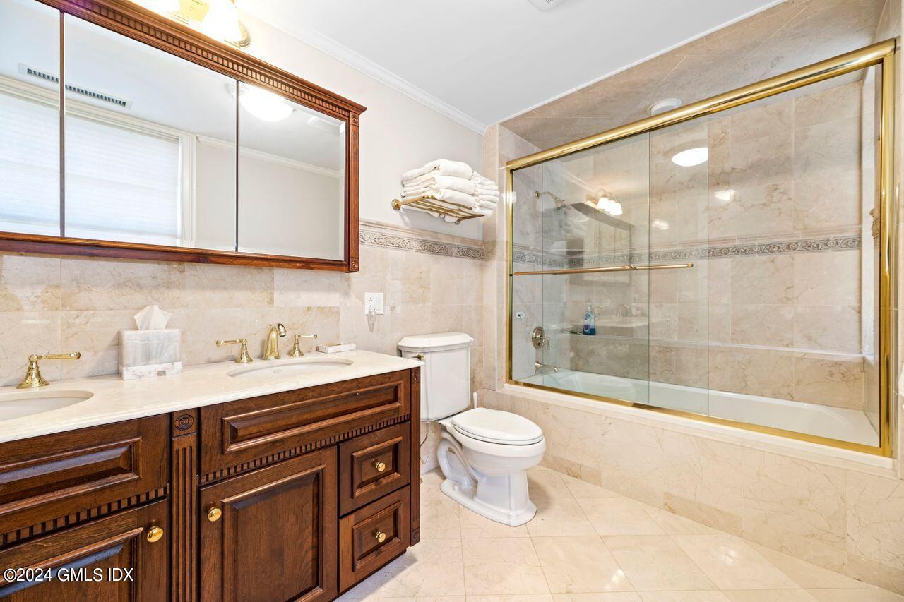 43 Maple Avenue, Unit 2 Greenwich, CT 06830 - Photo 8 of 17 a bathroom with a sink a toilet and shower