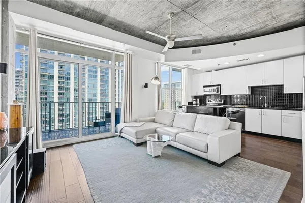 a living room with furniture and a large window