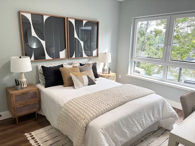 a bedroom with a bed and wooden floor