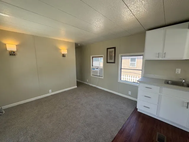a view of small space with wooden floor and windows