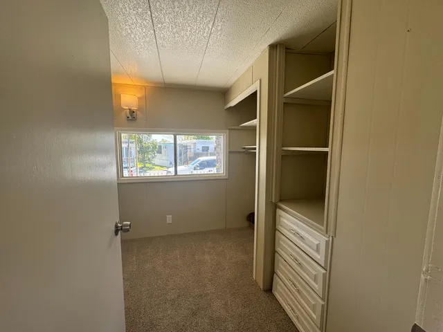 a view of an empty room with a window
