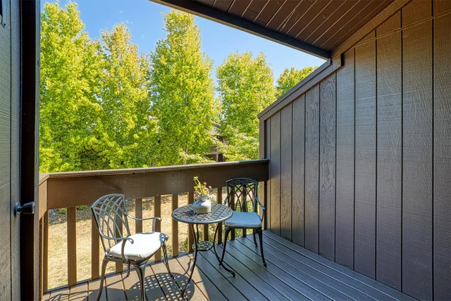 a balcony with table and chairs