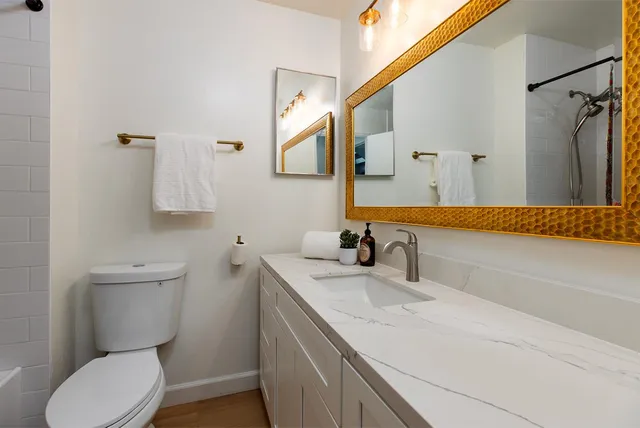 a bathroom with a sink toilet and shower