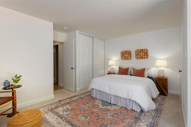 a bedroom with a bed and a table