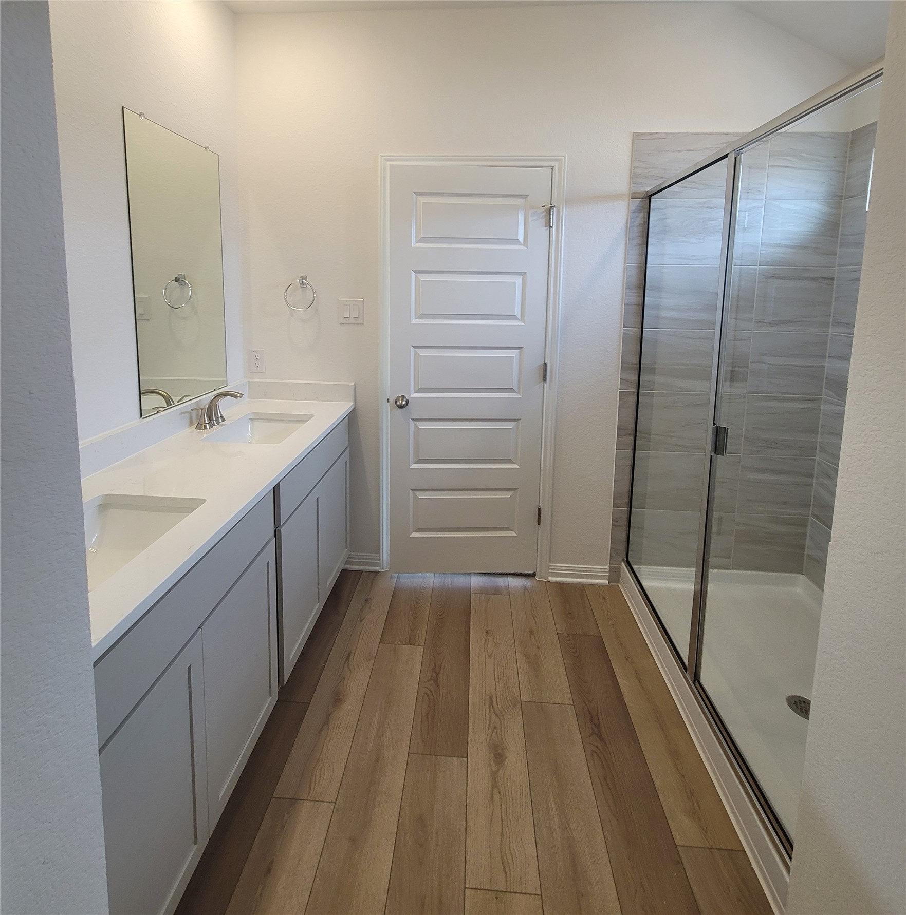 200 Callahan Loop Buda, TX 78610 - Photo 8 of 13 Dual vanity with white countertops, undermount sinks, and brushed nickel fixtures