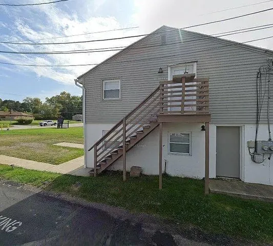 a kitchen with wooden cabinets and refrigerator