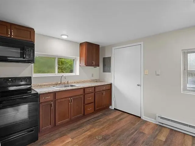 an empty room with windows and entrance