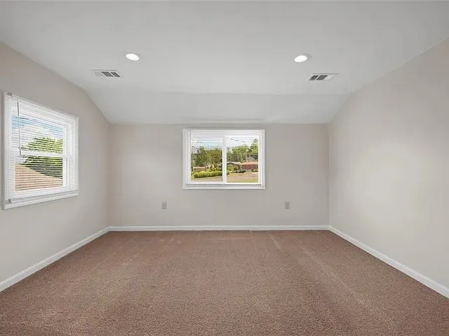 a bathroom with a toilet a sink a mirror a bathtub and vanity