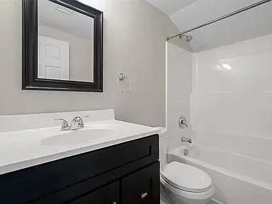 an empty room with windows and mirror