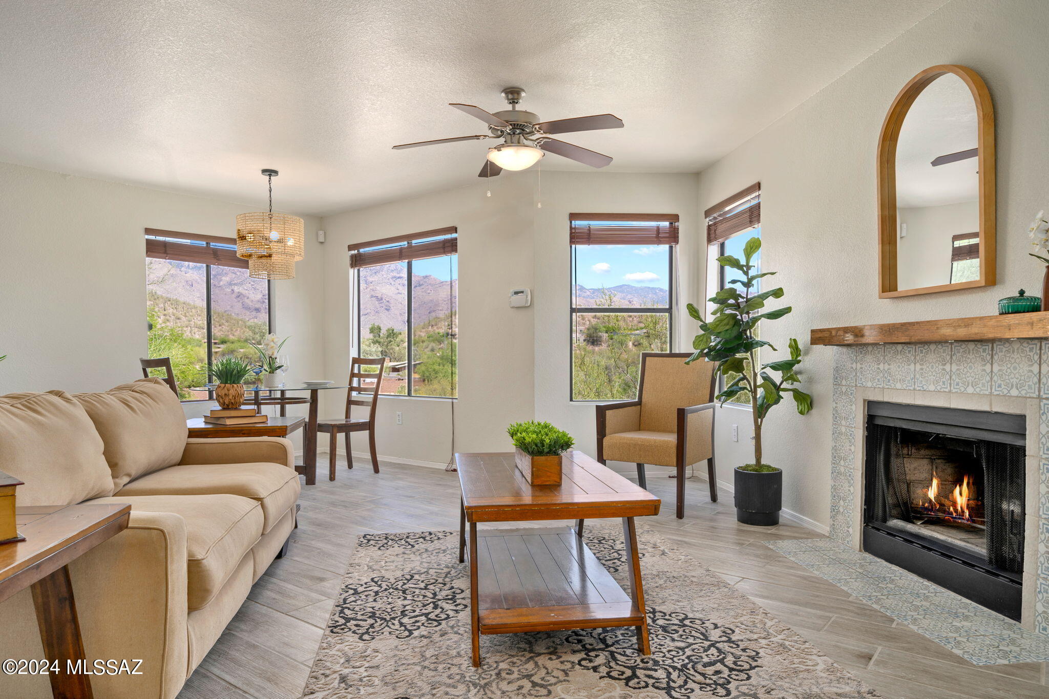 7255 East Snyder Road, Unit 4206 Tucson, AZ 85750 - Photo 3 of 33 a living room with furniture a chandelier and a fireplace