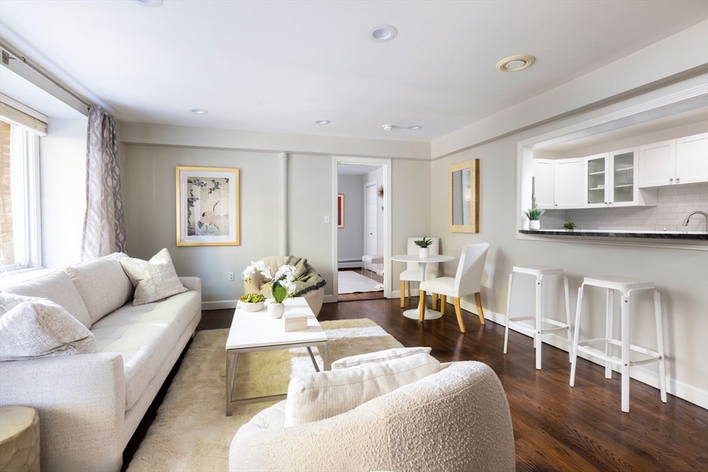 471 Washington Street, Unit B Brookline, MA 02446 - Photo 2 of 10 a living room with furniture and wooden floor