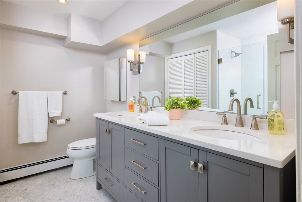 471 Washington Street, Unit B Brookline, MA 02446 - Photo 5 of 10 a bathroom with a sink double vanity and a toilet