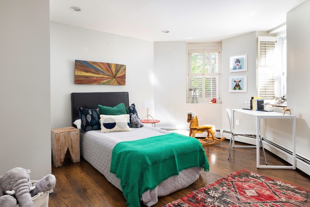 471 Washington Street, Unit B Brookline, MA 02446 - Photo 6 of 10 a bedroom with a bed and a large window