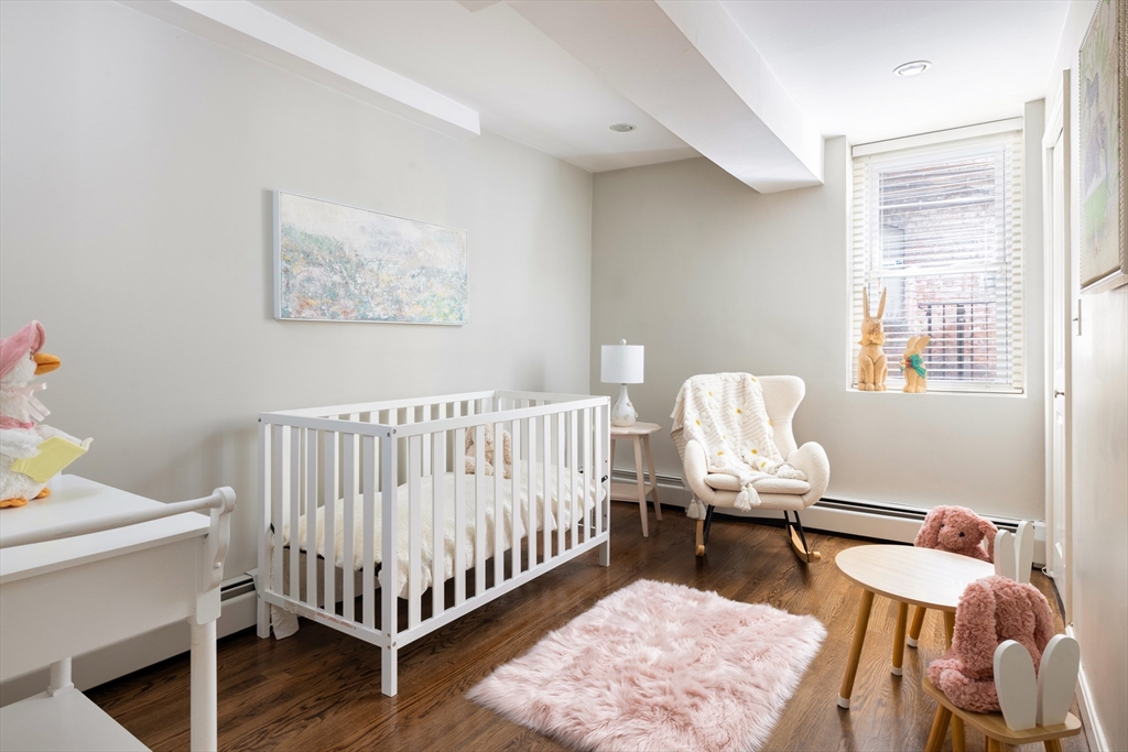 471 Washington Street, Unit B Brookline, MA 02446 - Photo 7 of 10 a bed room with furniture and wooden floor