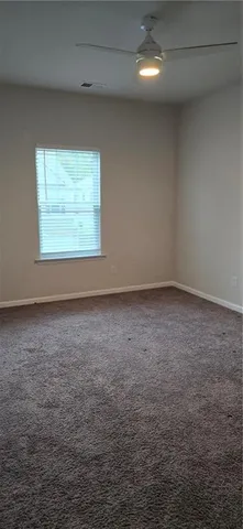 a bathroom with a toilet a sink and wooden floor