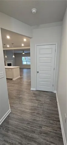 a view of a hallway with wooden floor