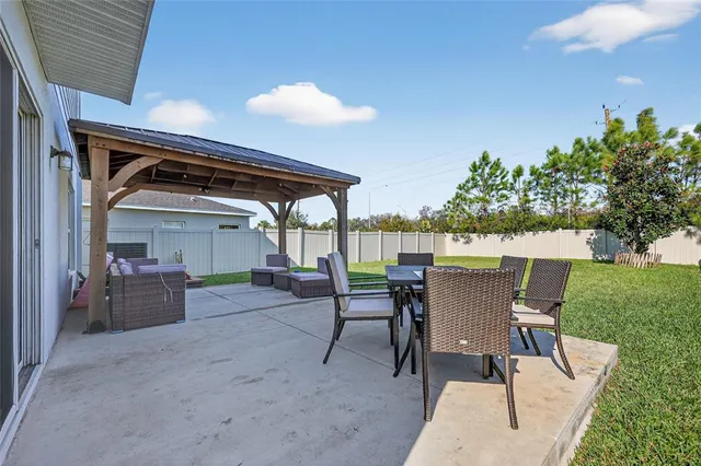a view of a house with a yard and sitting area