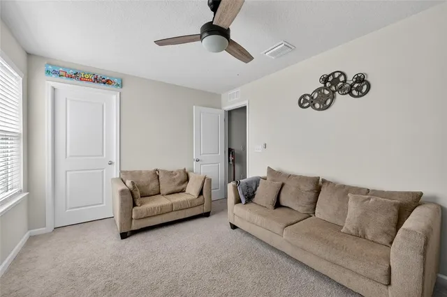 a bathroom with a bathtub shower sink vanity mirror and toilet