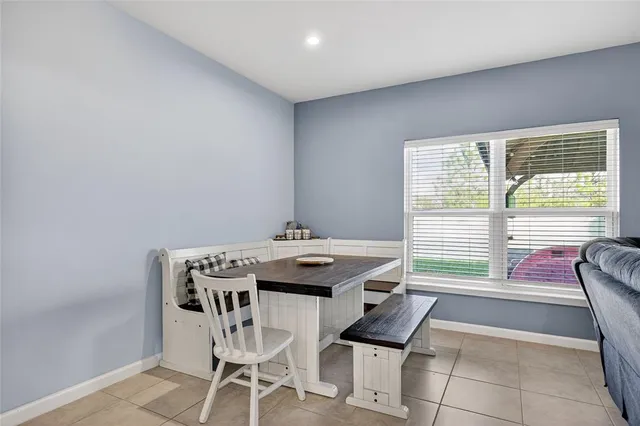 a dining room with furniture and window