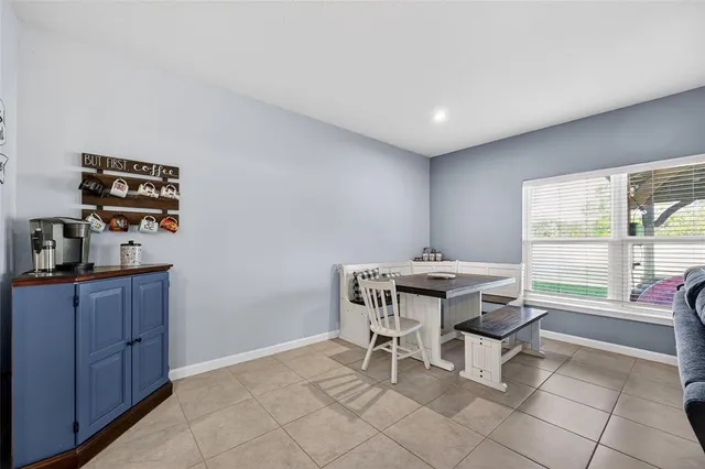 a living room with furniture and a ceiling fan