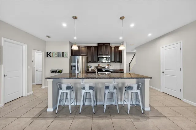 an aerial view of a city with lots of residential buildings ocean and mountain view in back