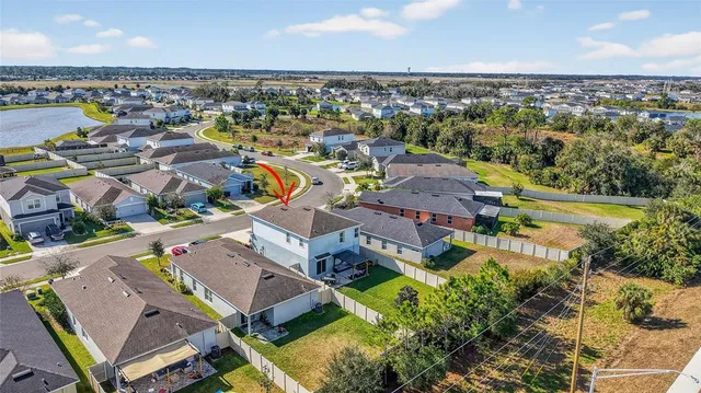 an aerial view of residential houses with yard