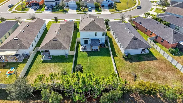 an aerial view of a house with a swimming pool yard and outdoor seating