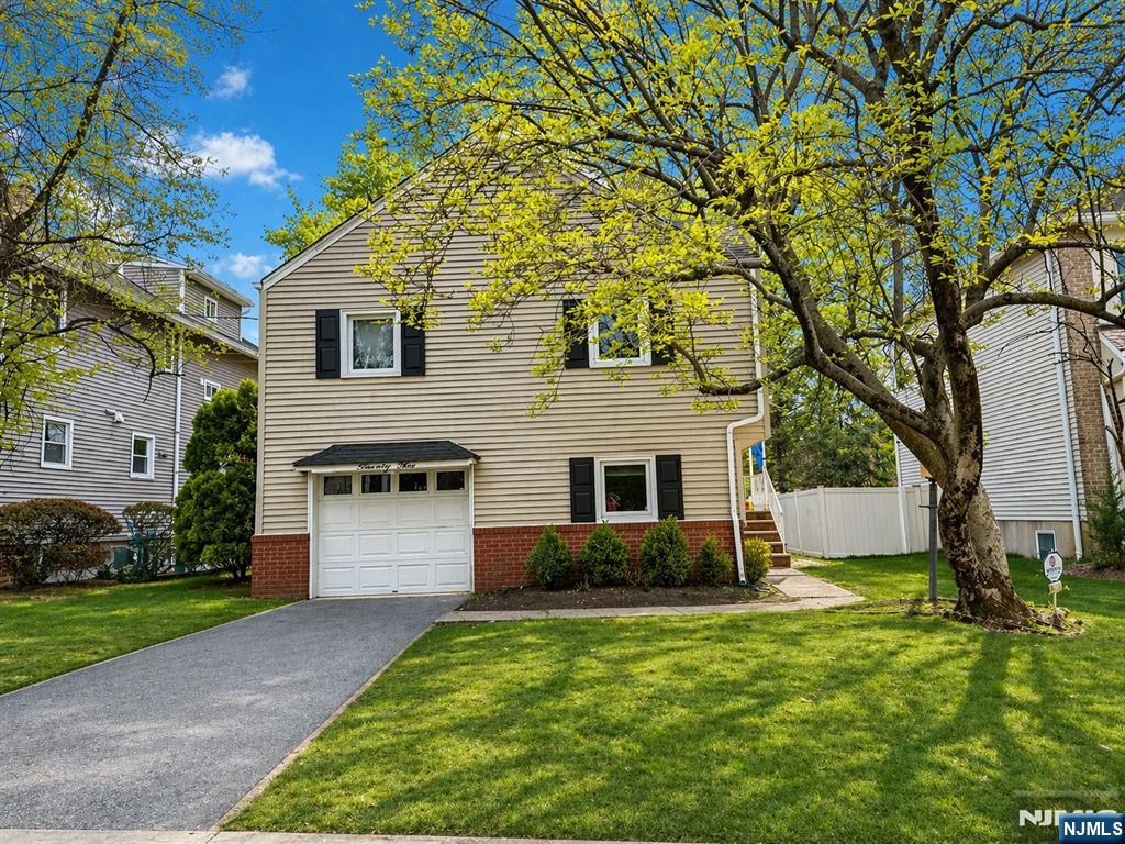 768 Dearborn Street Teaneck, NJ 07666 - Photo 1 of 10 a front view of a house with a yard and garage