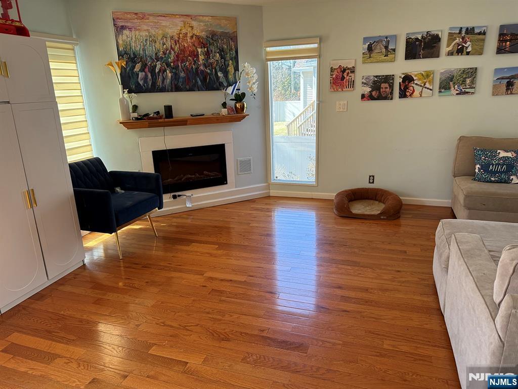 768 Dearborn Street Teaneck, NJ 07666 - Photo 2 of 10 a living room with furniture and a fireplace