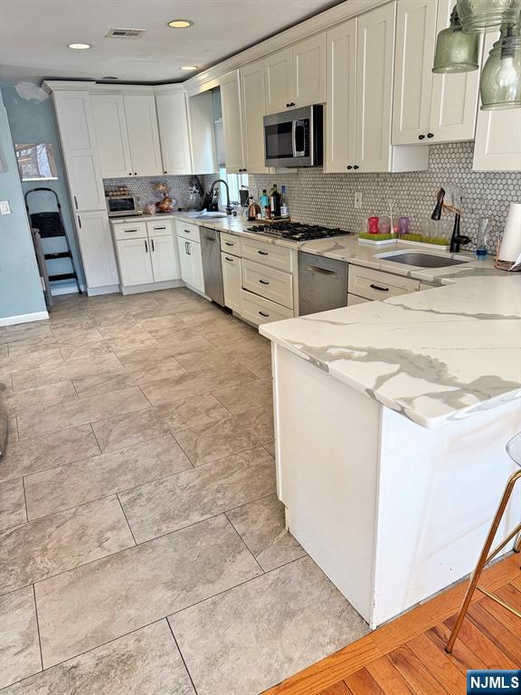 768 Dearborn Street Teaneck, NJ 07666 - Photo 4 of 10 a kitchen with stainless steel appliances granite countertop a sink a stove a microwave and cabinets