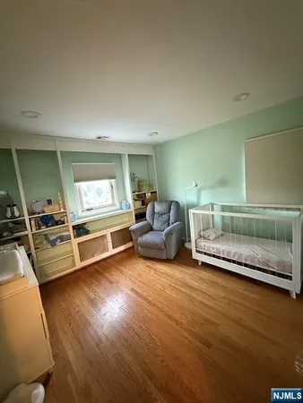a bedroom with furniture and a wooden floor
