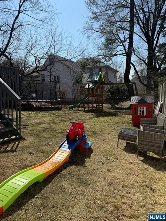 a backyard of a house with yard fire pit and outdoor seating