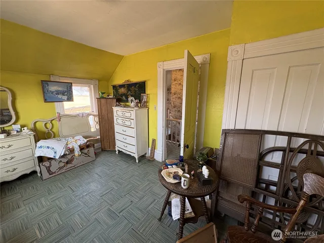 a bedroom with furniture and a window
