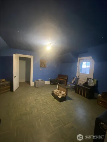 a living room with furniture and a lamp