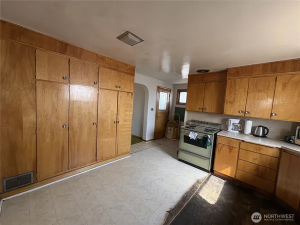 a kitchen with stainless steel appliances granite countertop a refrigerator a stove and a sink