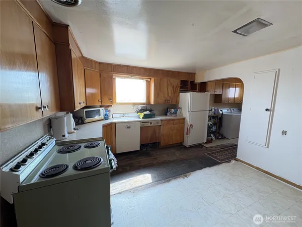a kitchen with a sink appliances and cabinets