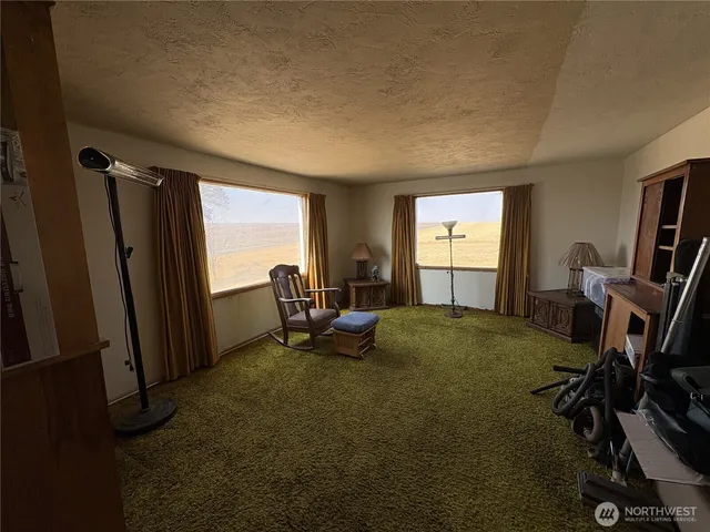 a view of a room with gym equipment and a large window