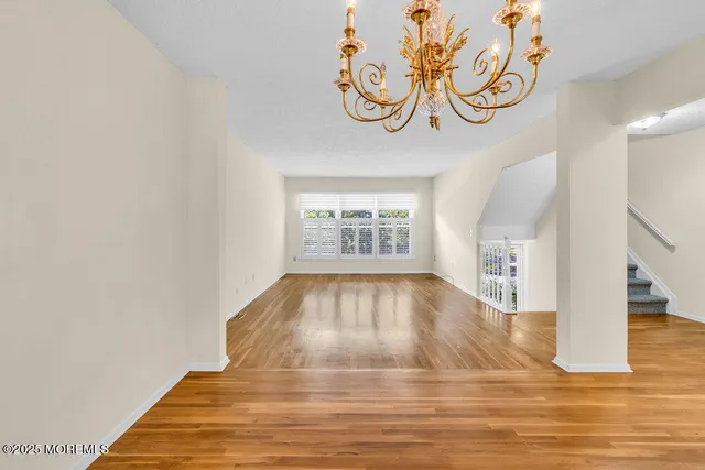 a view of an empty room with window and fireplace
