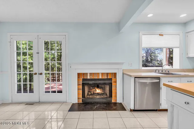 a view of an empty room with a fireplace and a window