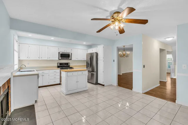 a kitchen with a refrigerator and a sink