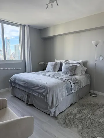 a bedroom with a bed and window