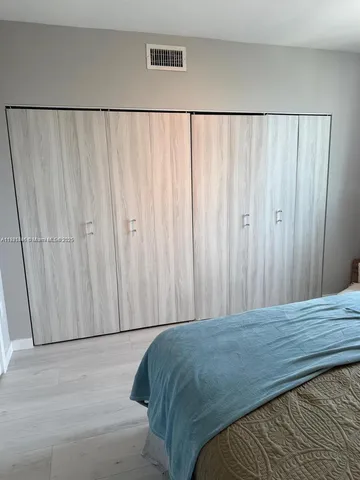 a bedroom with a wooden bed and curtain