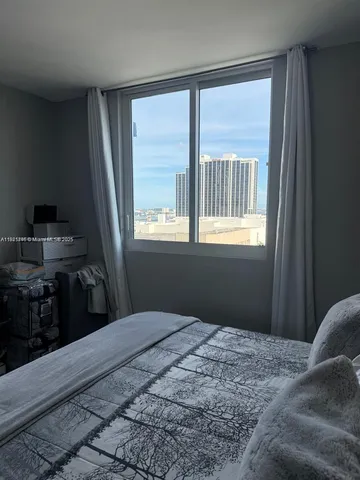 a bedroom with a bed dresser and a window